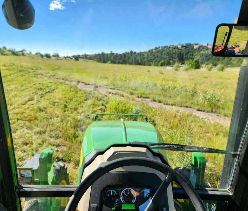 View from the tractor cab mowing tall native grass